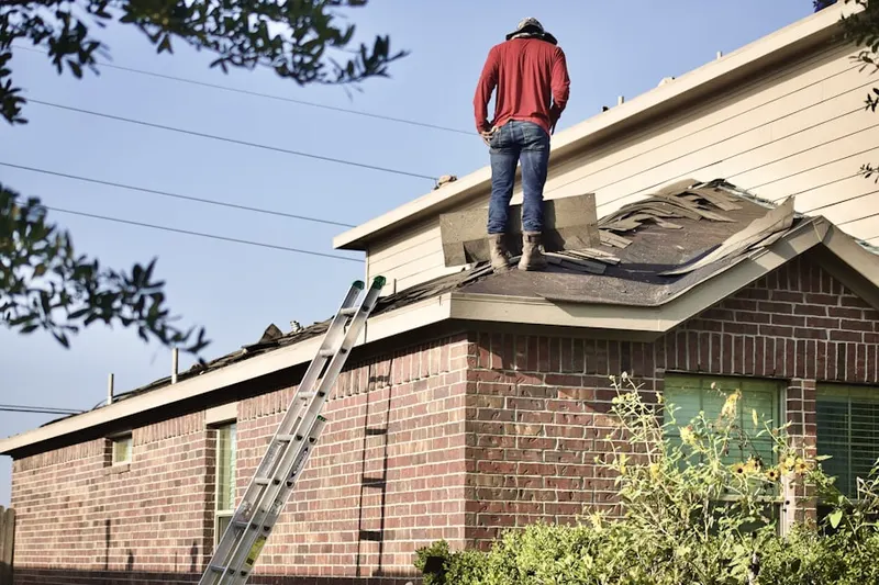 Professional roofer working on a residential roof in Bay Colony
